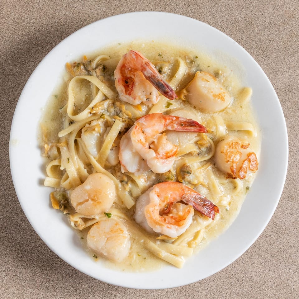 Carbonara's seafood fettuccine with shrimp, scallops, and clams in a creamy sauce.