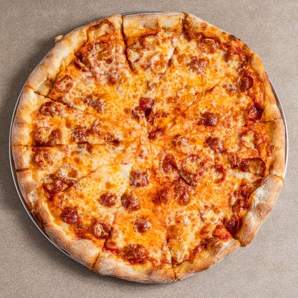 A whole Carbonara's pepperoni pizza, cut into eight slices, on a metal tray.